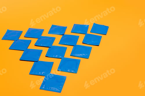 Preview: flat lay with condoms in packs isolated on orange