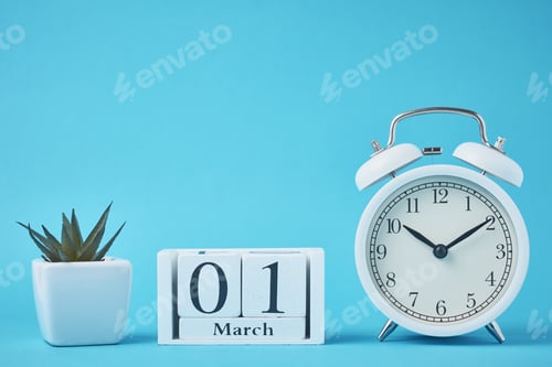 Preview: White retro alarm clock with bells and wooden calendar blocks with date 1 march