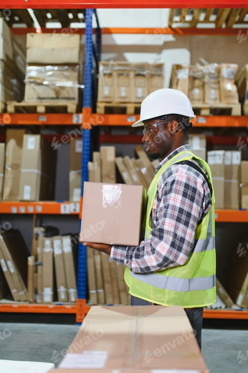 Preview: Portrait of a handsome african american warehouse worker in overalls and a helmet