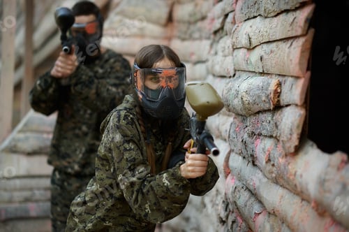 Preview: Paintball players shoots with guns from shelter