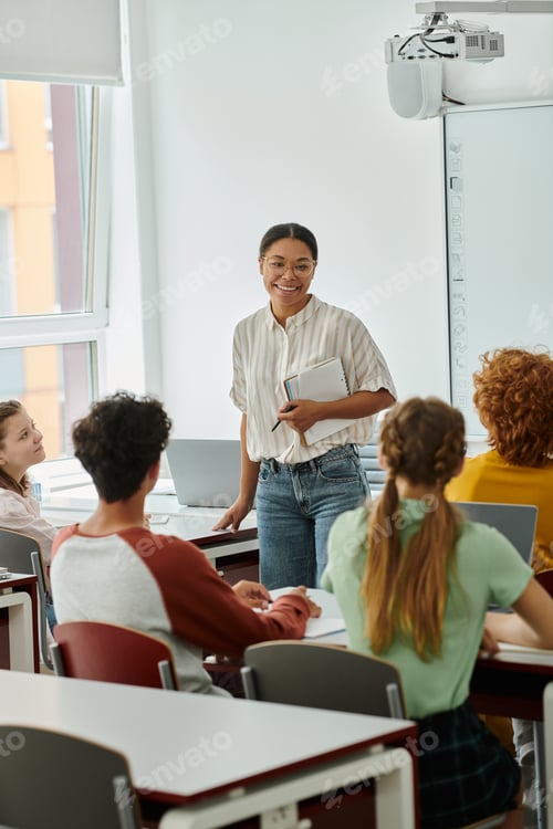 Preview: Students in Classroom Learning with Smiling Teacher