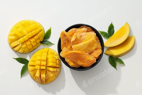 Preview: A bowl of dried mango chips with fresh sliced mango
