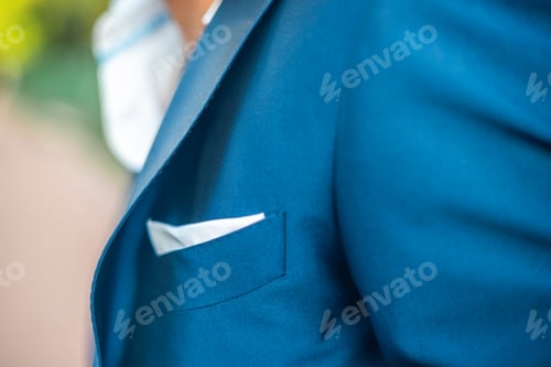 Preview: Closeup shot of a person wearing a blue tuxed