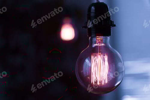 Preview: Glowing Filament Bulb Illuminating in Darkness