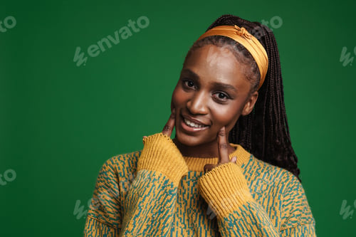 Preview: Black young woman smiling and pointing fingers at her cheeks