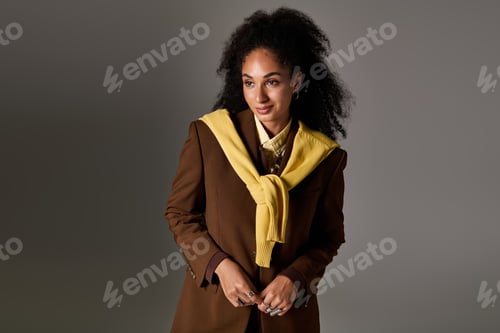 Preview: Trendy autumn style showcased by a beautiful woman in a studio setting