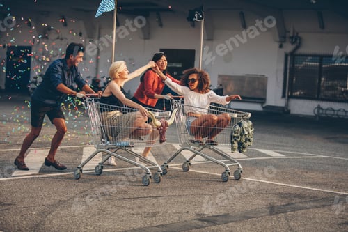 Preview: Young friends racing with shopping carts