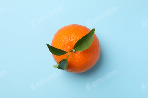 Preview: Ripe mandarin with leaves on blue background