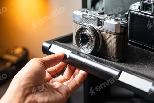 Preview: Hand Pulling Camera Storage Drawer with Vintage and SLR Cameras