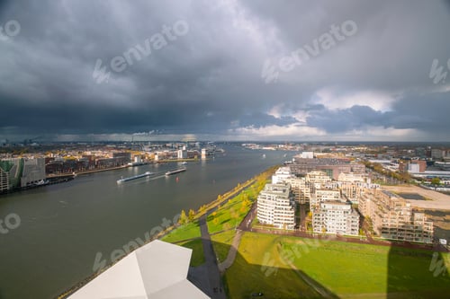 Preview: An expansive view of a city skyline under a dramatic cloudy sky