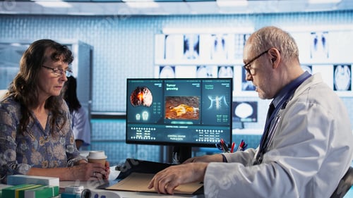 Preview: Oncology consultation takes place as a senior medic explains radiology scan