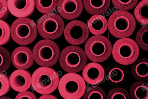 Preview: Close up of colored thread coils, thread spools background. Color of the year 2023, viva magenta.