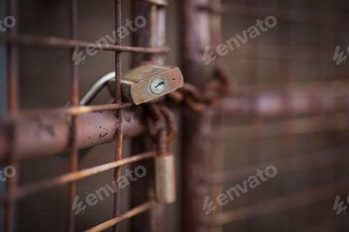 Rusted Metal Gate Secured with Padlocks Close-Up
