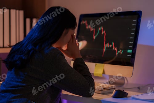 Preview: Stressed businesswoman looking at declining financial chart on computer screen