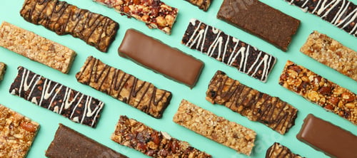 Preview: Flat lay with tasty granola bars on mint background, top view
