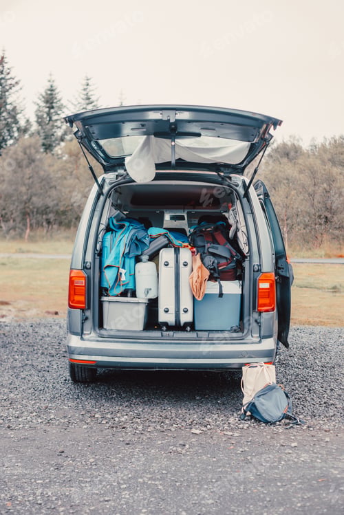 Preview: Close up of a van filled with suitcase, bag and road trip stuff ready to start the route traveling a