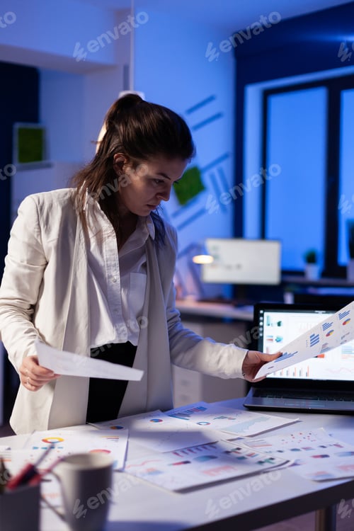 Preview: Busy business woman looking on financial reports