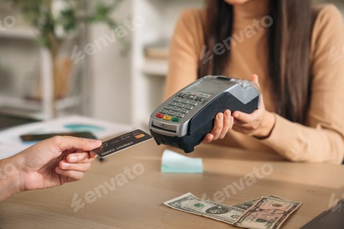 Preview: Happy woman hold card for payment at shop. Female using technology for money transfer.