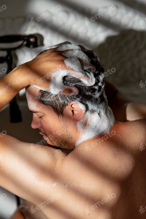Preview: man washes under the shower in the bathtub