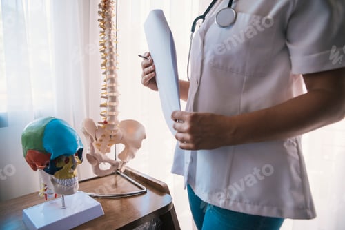 Preview: female doctor with artificial bones and papers