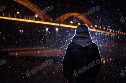 Preview: silhouette of a man on the background of falling snow in winter
