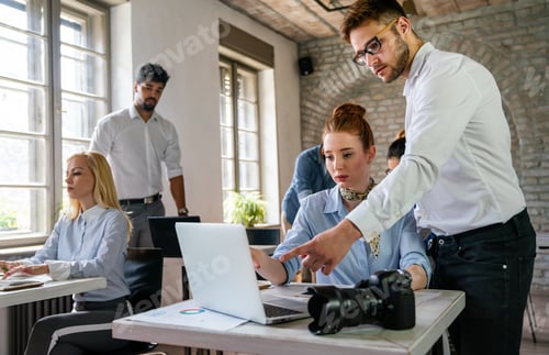 Preview: Portrait of creative designer team smiling while working together in the modern office.