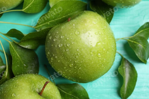 Preview: Fresh ripe green apples with water drops on turquoise wooden table, flat lay