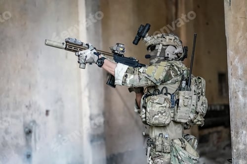 Preview: Soldier in full US MARSOC armed with assault rifle run through the abandoned building. Military