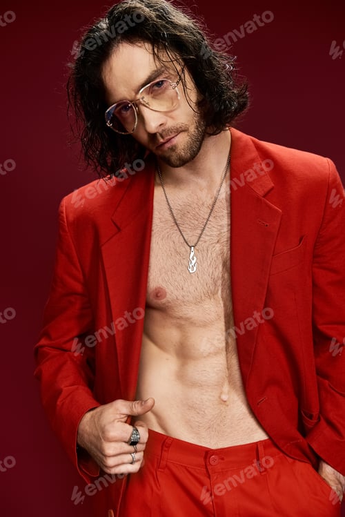 Preview: The stylish visionary: shirtless man in red suit and glasses