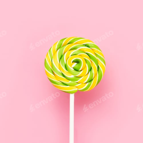 Preview: Yellow-green lollipop swirl on a white stick over pink background. Top view, copy space