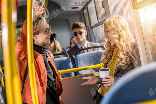 Preview: young couple talking and smiling each other in bus