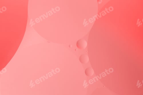 Preview: a close up of oil and water bubbles on a pink background