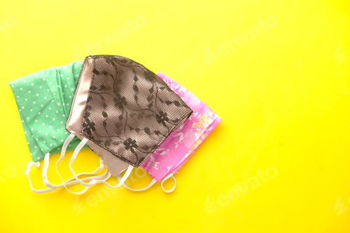 Preview: cloth face masks on yellow background top down