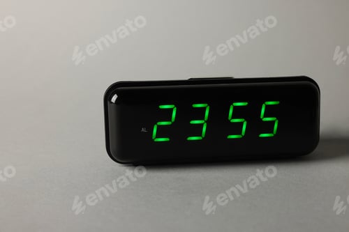 Preview: Digital alarm clock showing 23:55 o'clock on grey background, space for text