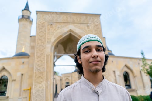 Preview: portrait of a young man of Muslim appearance leaving the mosque after prayer on a terrace
