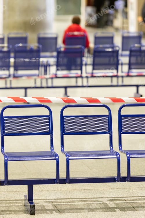 Preview: Stretched protective red tape on the chairs. Social distancing, Covid-19 pandemic