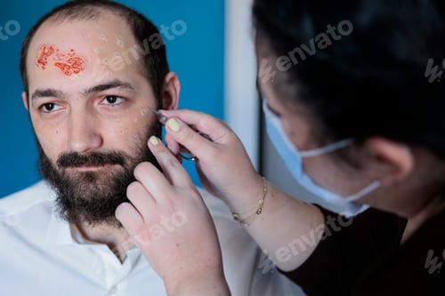Preview: Woman peeling actor skin in makeup department, preparing for zombie movie