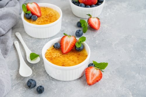 Preview: Creme brulee. Traditional French vanilla cream dessert with caramelised sugar and fresh berries