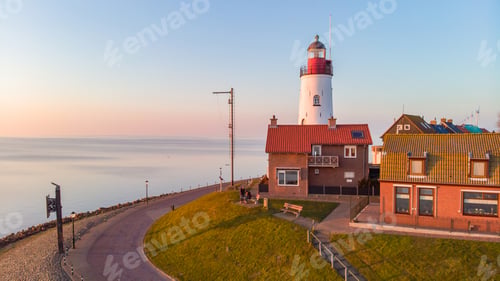 Preview: Urk Flevoland Netherlands sunset at the lighthouse and harbor of Urk Holland