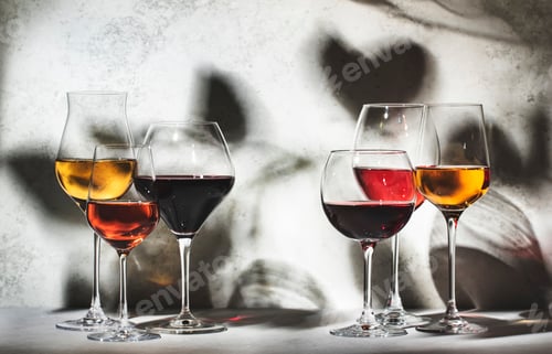 Preview: Wines assortment. Red, white, rose wine in wineglasses on gray background.