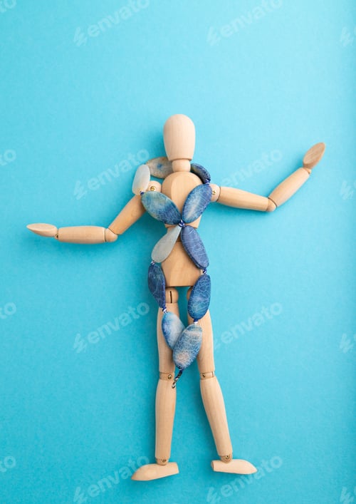 Preview: Wooden mannequin with blue agate beads on blue pastel background. copy space.