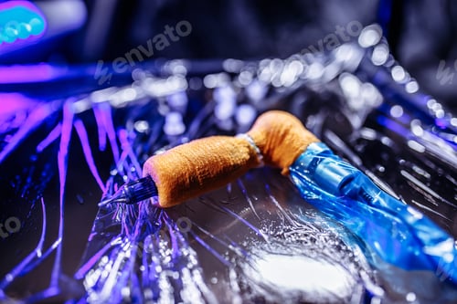 Preview: Tattoo machine on the table with neon lights