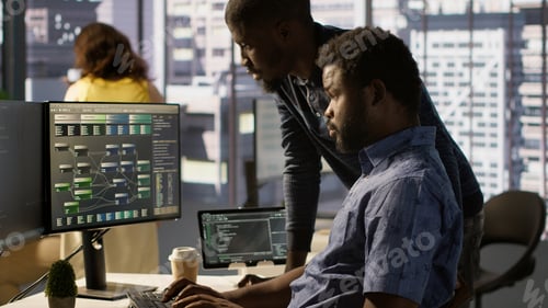 Preview: IT specialist assisted by coworker to compare data in office