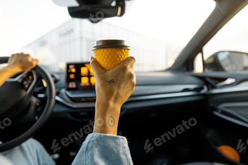Preview: Woman drives car with a coffee