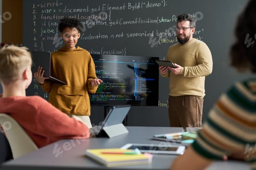 Preview: Teenage Boy Presenting Programming Project with Caucasian Male Teacher Observing