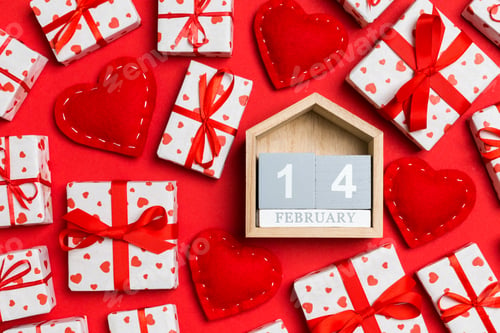Preview: Top view of wooden calendar, white gift boxes and red textile hearts
