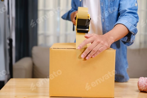 Preview: Young business owner working and selling online product and prepare packaging process.