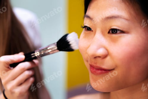 Preview: portrait of a woman receiving a professional makeup