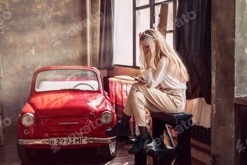 Preview: A girl movie actor is resting with a phone in her hands during a break between filming