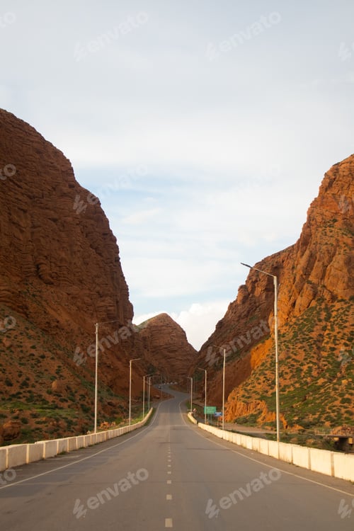 Preview: Road through a towering red rock canyon with streetlights